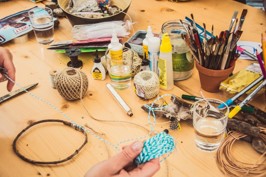 A-Girl-Holding-A-Blue-White-Rope-Brushes,glasses-Of-Water-Glue-On-A-Table