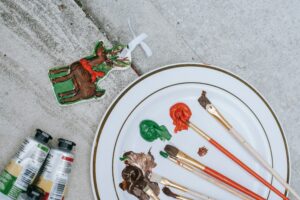   Two-Color-Bottle-Plate-And-Painting-Brushes-On-A-Table