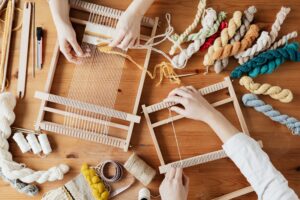 Two-women-hands-weaving-with-thread