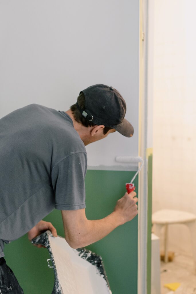 A-person-painting-wall-with-paint-roller